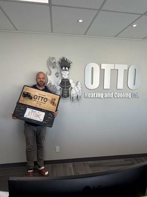 Kris Otto with Otto Heating and Cooling signage